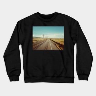 Canadian prairie landscape with a country road near Pincher Creek, Alberta, Canada. Crewneck Sweatshirt